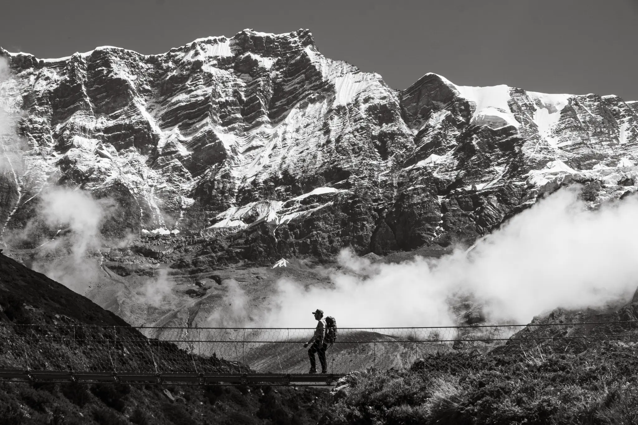Annapurna Circuit - Trekker on suspension bridge